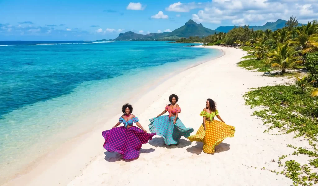 Colorful dancers on a beach