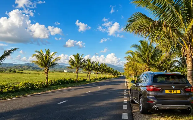 Rental car driving in Mauritius on a bright sunny day.