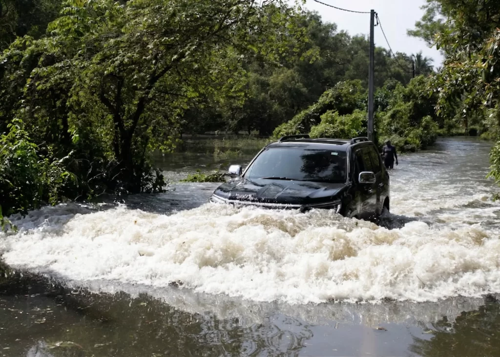 Car navigating through flooded road